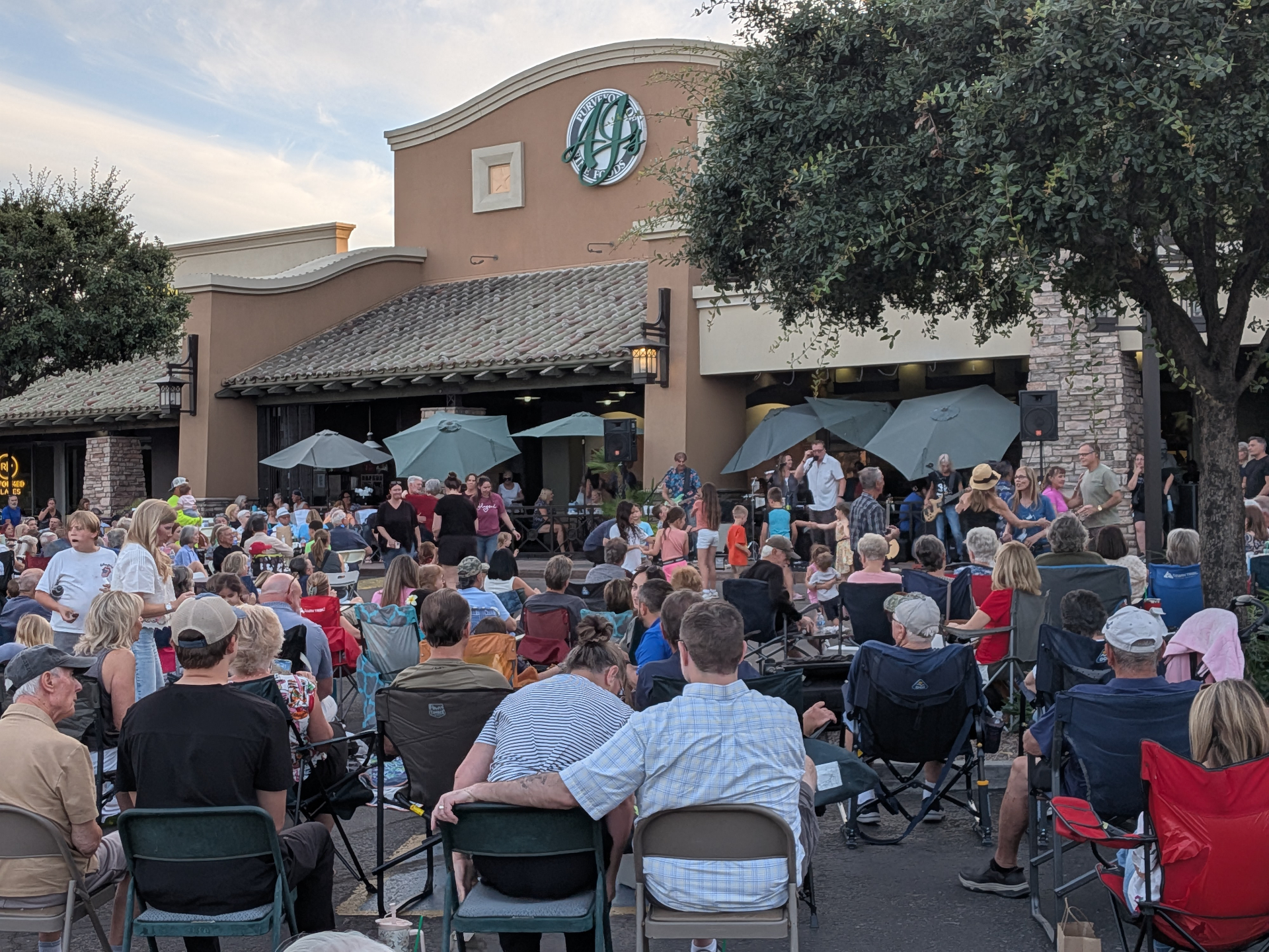 A lively community festival at a shopping center plaza